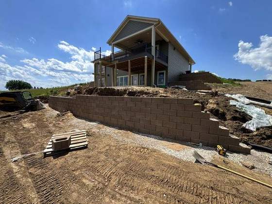 Block retaining wall going in below a walkout ranch during construction